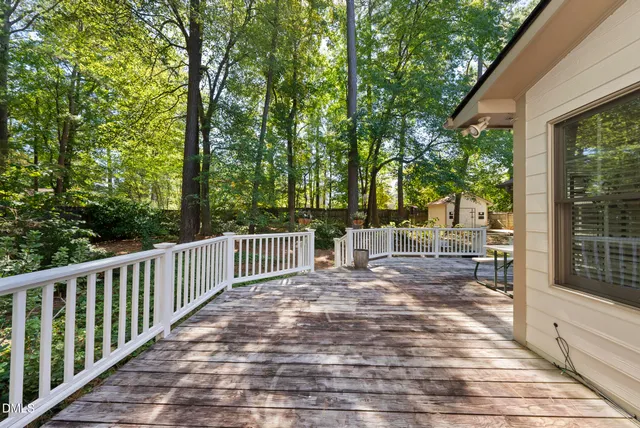 a view of balcony with wooden floor and outdoor seating