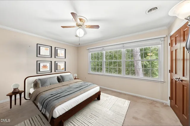 a bedroom with a large bed and a window