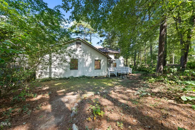 a view of a yard with a house and large tree