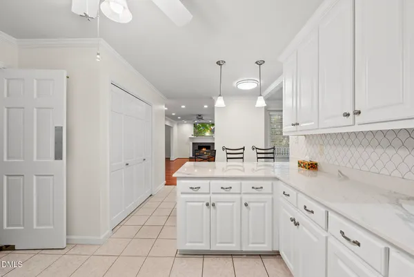 a view of an empty room with a fireplace and a window