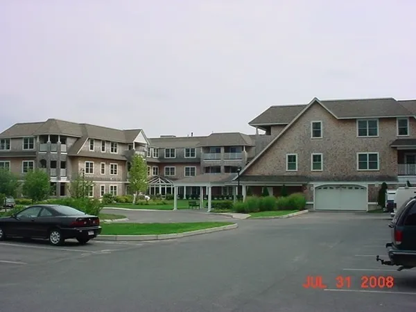 a view of house with a big yard and large trees