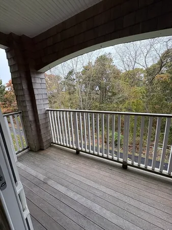 a view of a balcony with wooden floor
