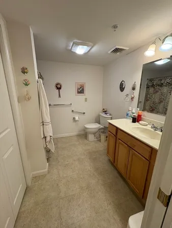 a bathroom with a sink a toilet and a mirror