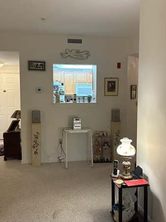 a room with furniture a chandelier and a window