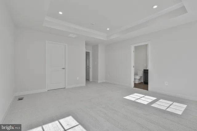 a bathroom with a sink a toilet a mirror and shower