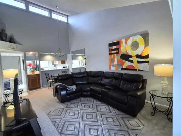 a living room with furniture and a chandelier
