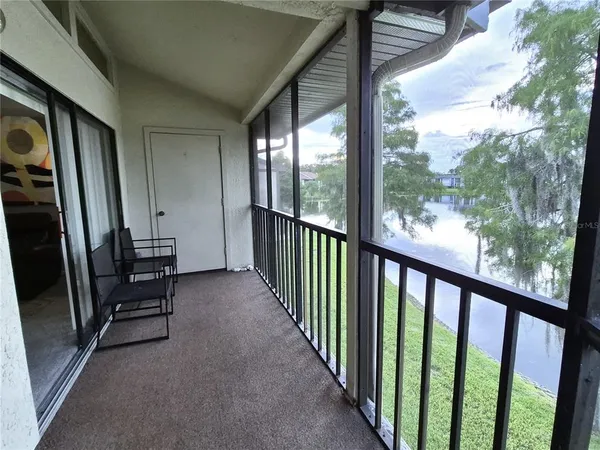 a view of a hallway with wooden floor and stairs