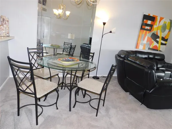 a dining room with furniture and wooden floor