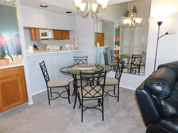a view of a dining room with furniture and chandelier