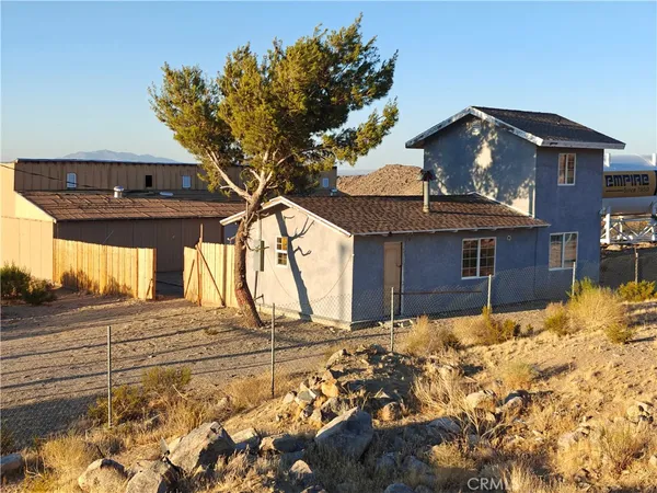 a view of a house with snow on the background
