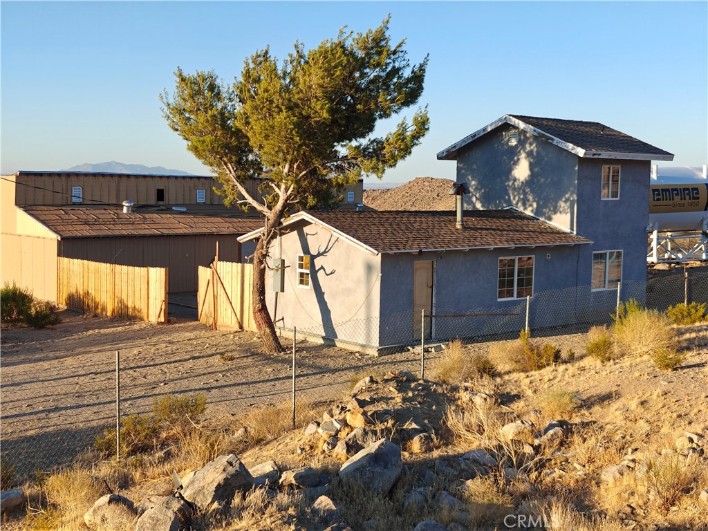 a view of a house with snow on the background