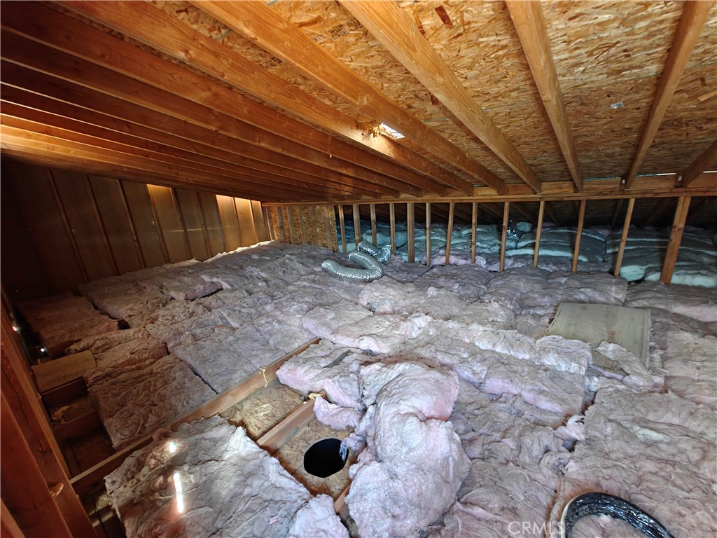31576 Emerald Road Lucerne Valley, CA 92356 - Photo 34 of 44 a view of an empty room with wooden floor