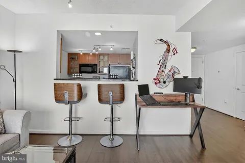 a living room with furniture and kitchen view