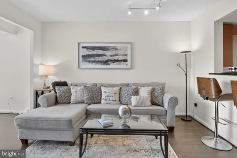 a living room with furniture and a lamp