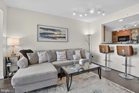 a living room with furniture and a lamp
