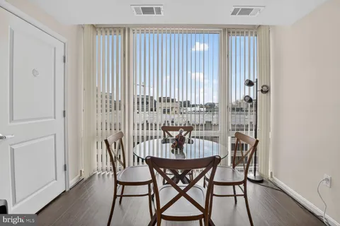 a dining room with furniture and wooden floor