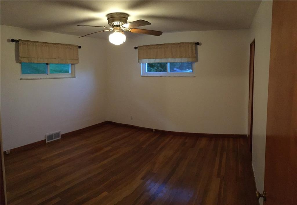 52 East Union Road Cheswick, PA 15024 - Photo 8 of 15 a view of an empty room with a window and wooden floor