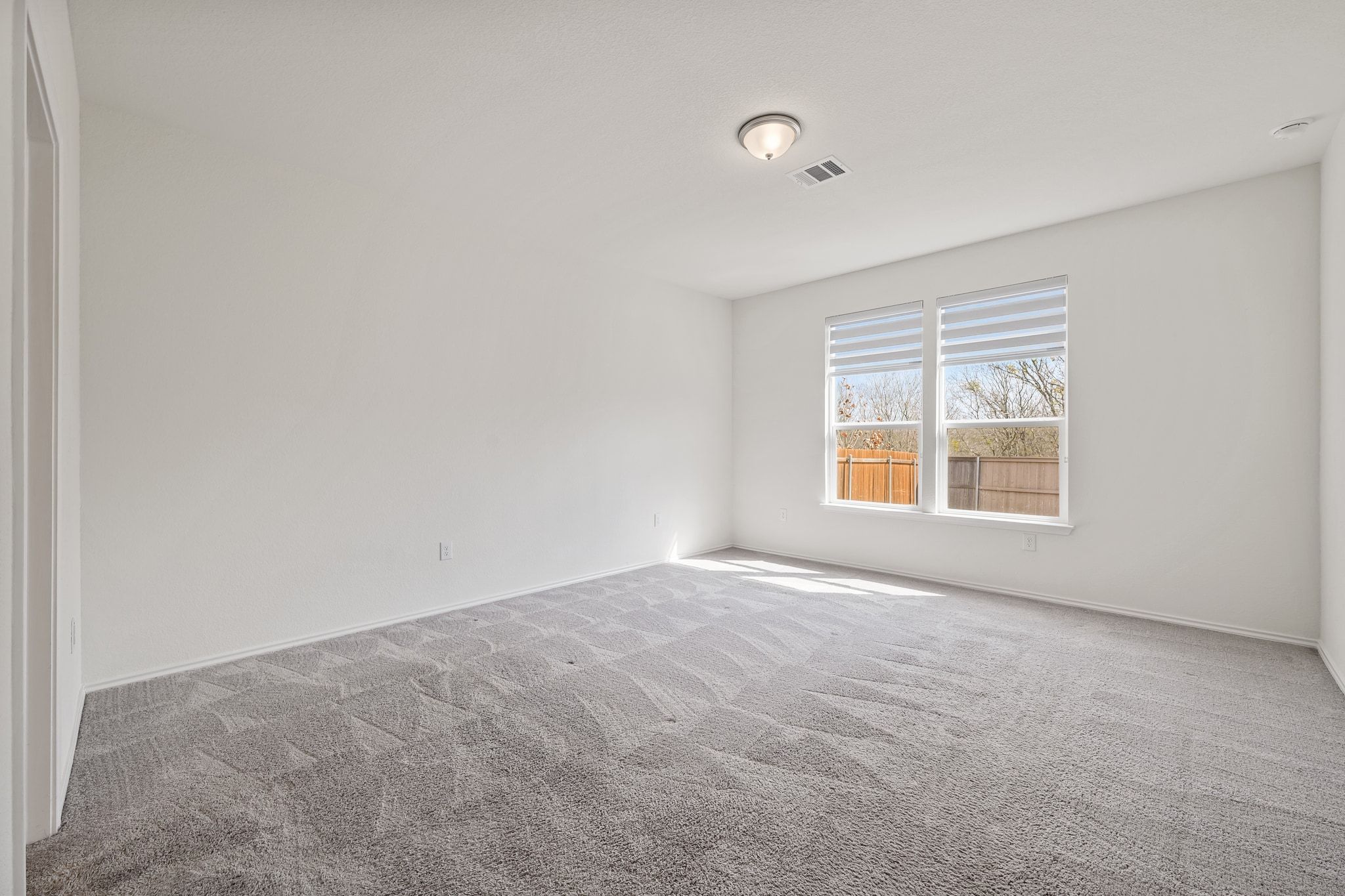 7715 Libretto Lane Austin, TX 78744 - Photo 13 of 39 This home comes with four bedrooms including this spacious and secluded main floor primary suite.