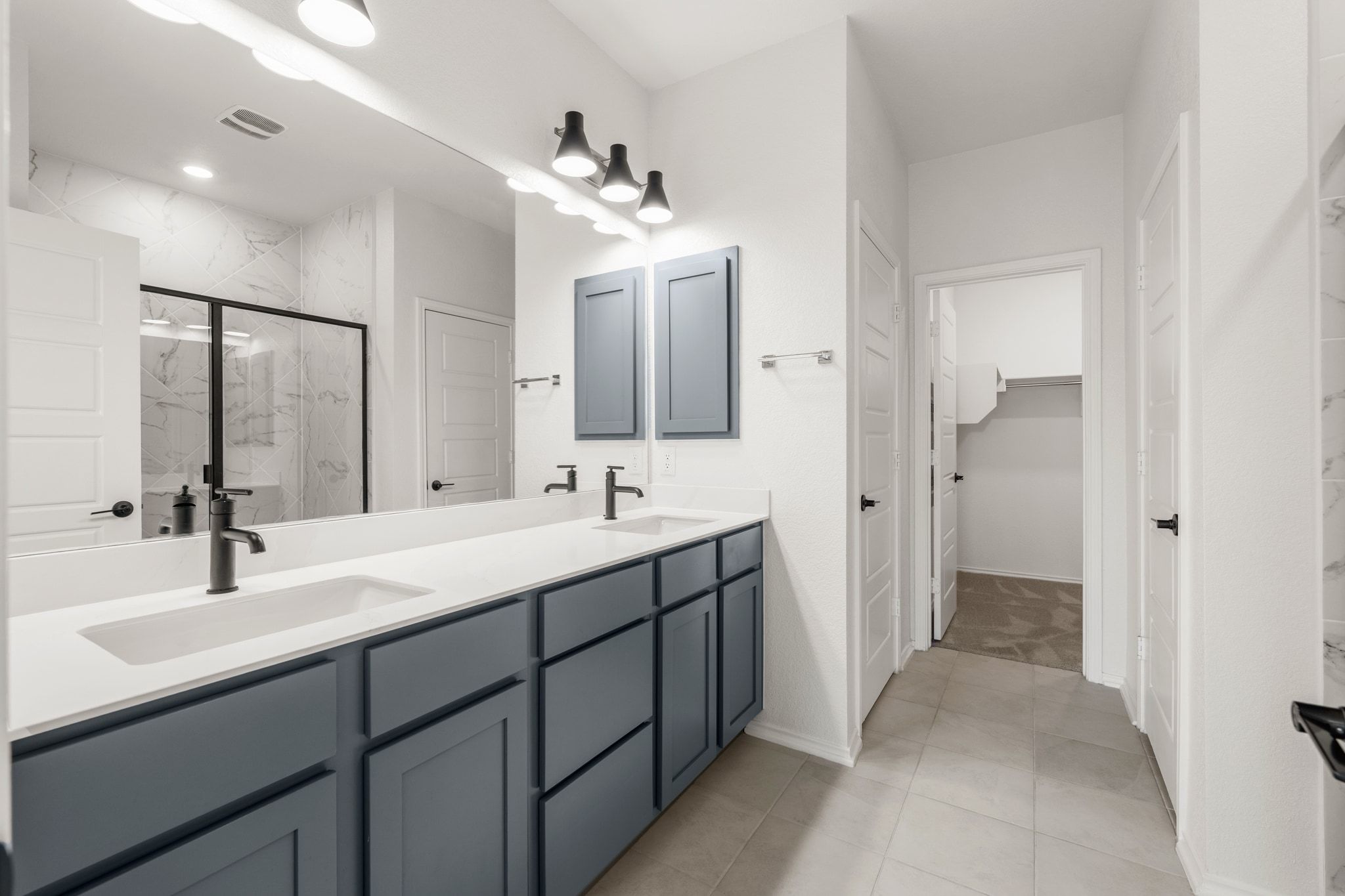 7715 Libretto Lane Austin, TX 78744 - Photo 15 of 39 Enjoy your own private ensuite bath with a spacious dual vanity, linen closet, private toilet, and walk-in closet.