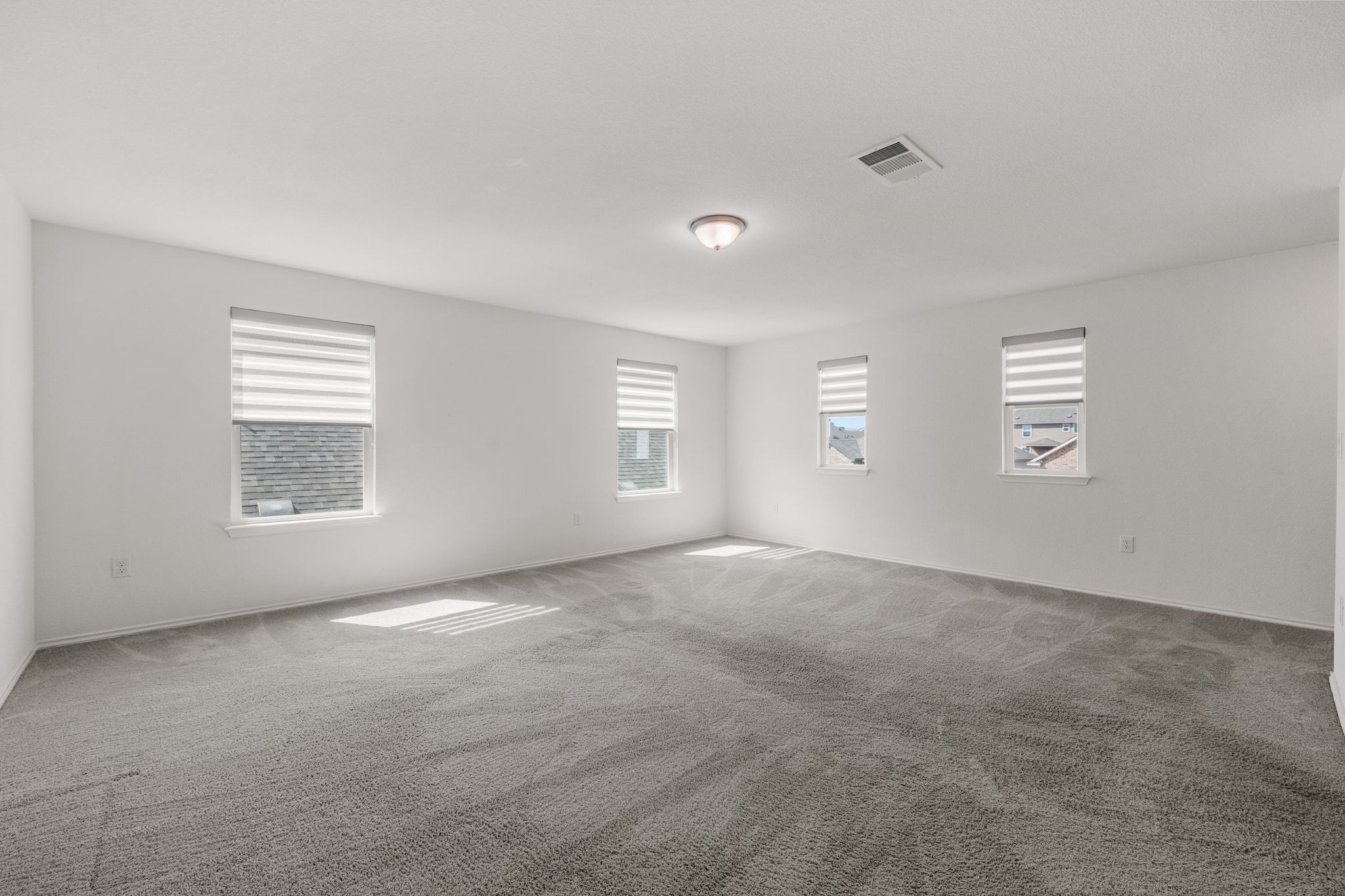 7715 Libretto Lane Austin, TX 78744 - Photo 18 of 39 The second floor bonus living area comes wrapped in windows with tall ceilings and comfortable carpeting.