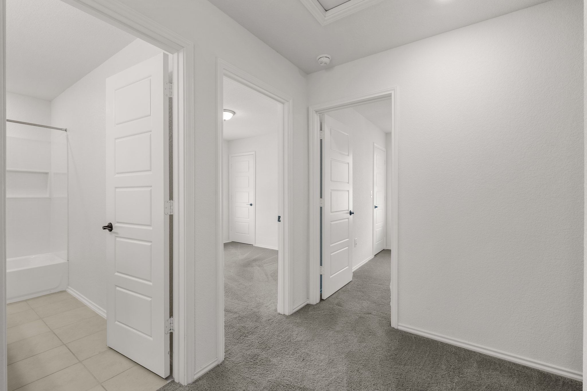 7715 Libretto Lane Austin, TX 78744 - Photo 21 of 39 Comfortable carpeting runs through all of the bedrooms while the bathrooms are tiled.