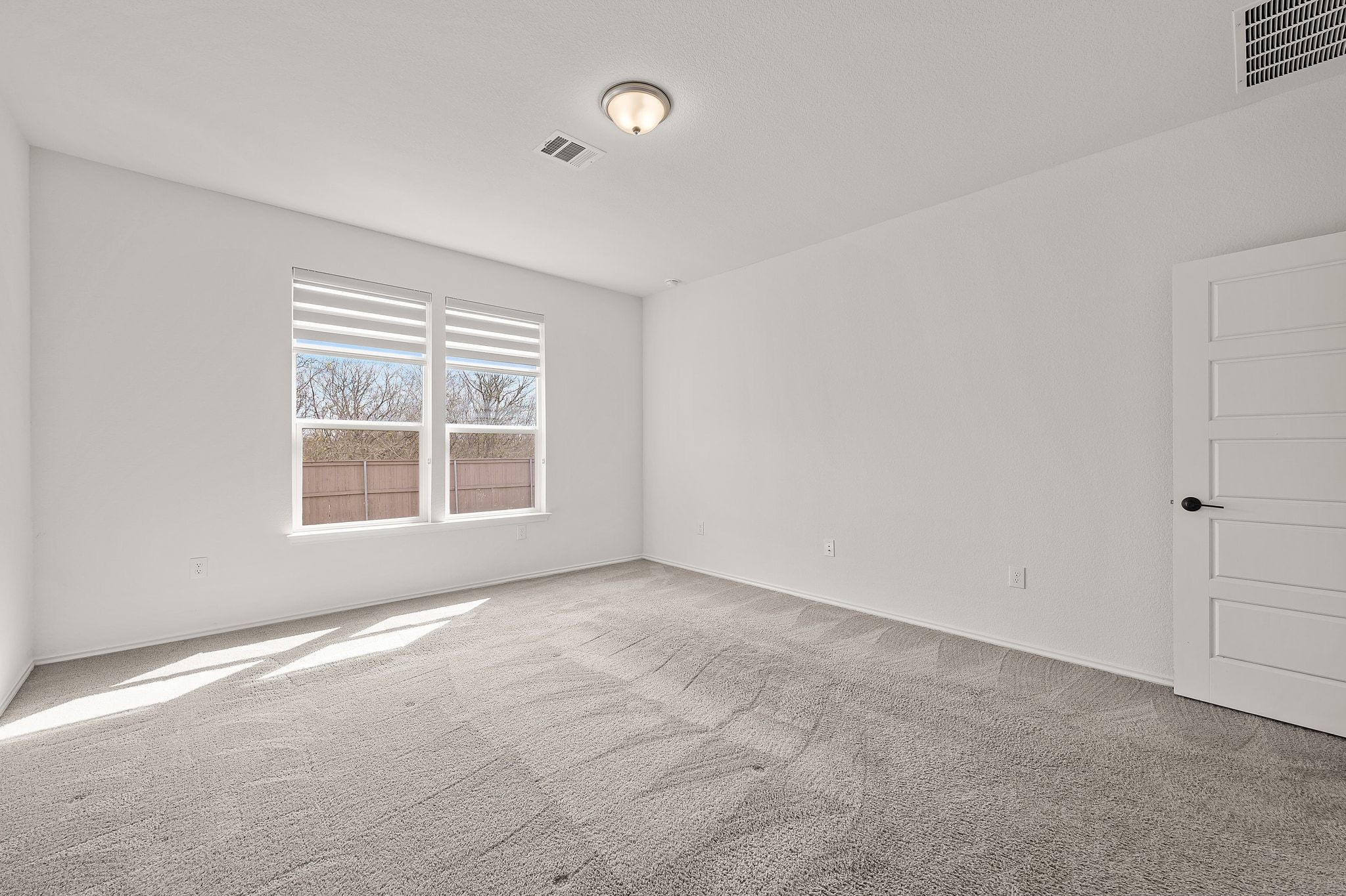 7715 Libretto Lane Austin, TX 78744 - Photo 4 of 39 The primary suite is secluded away on the main floor overlooking the backyard and greenbelt making it a peaceful and private retreat.