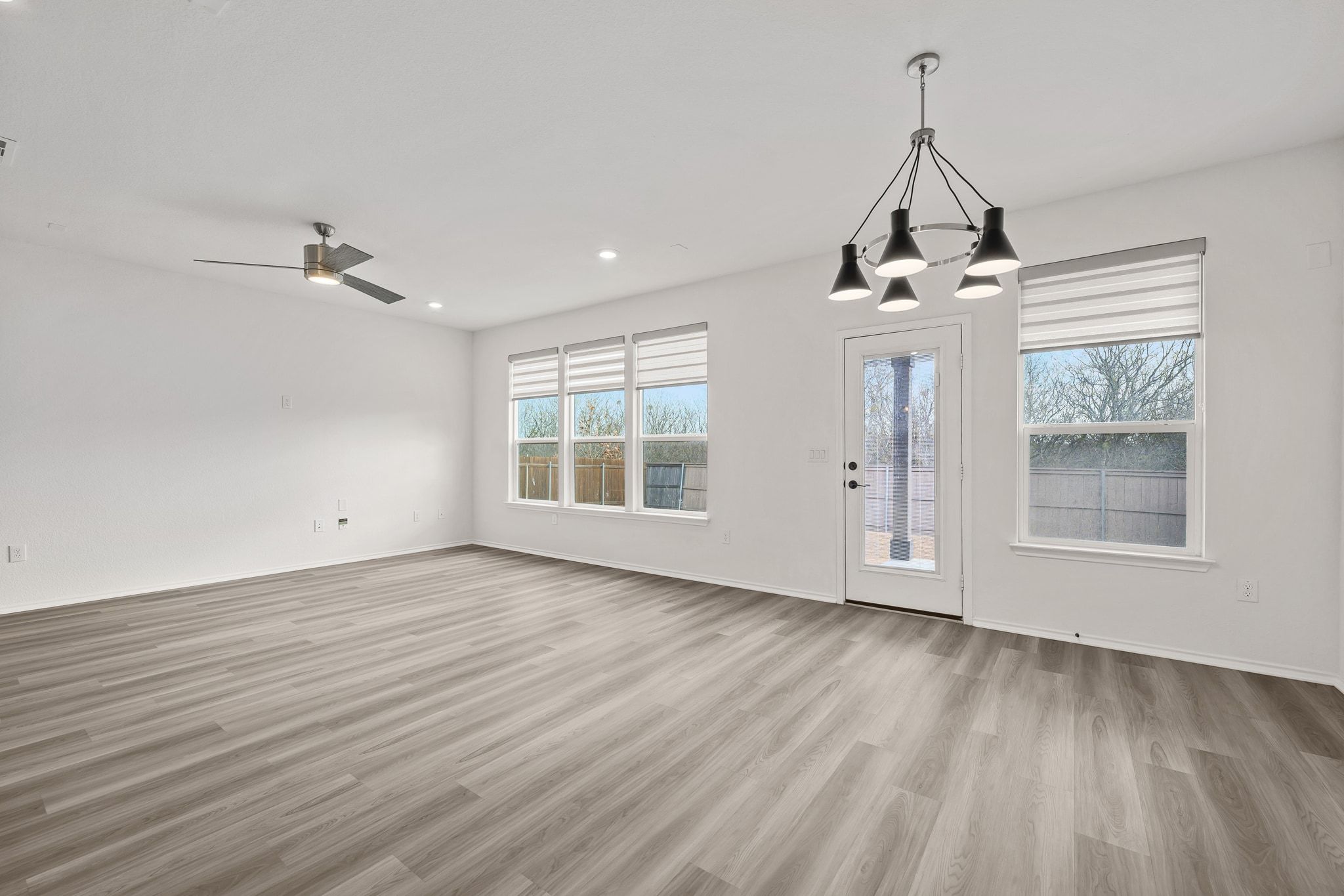 7715 Libretto Lane Austin, TX 78744 - Photo 8 of 39 The back wall of the home is lined with windows that frame greenbelt views while bathing the home in natural light.