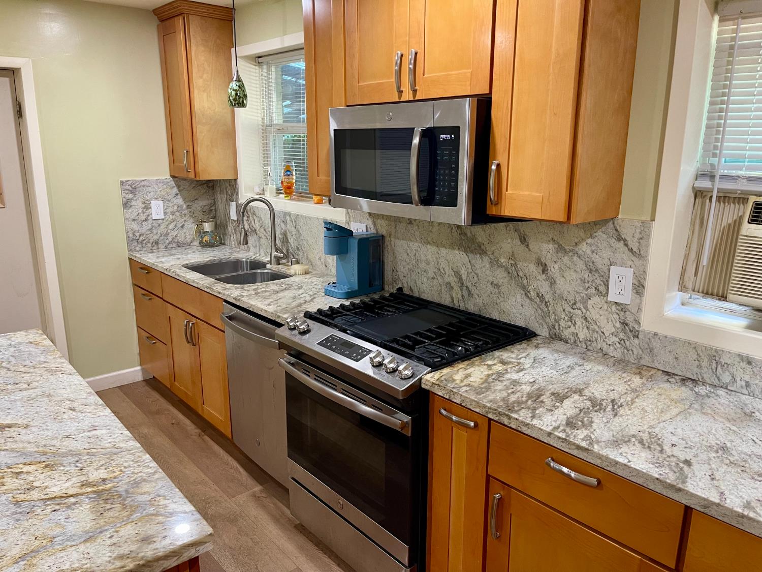 1736 6th Street Concord, CA 94519 - Photo 13 of 64 a kitchen with granite countertop a sink a stove and microwave