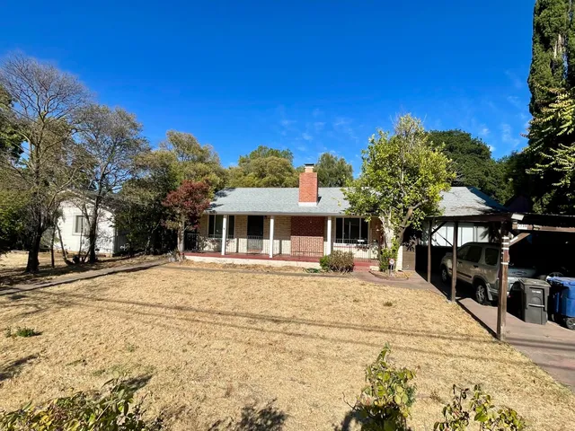a front view of a building with a yard