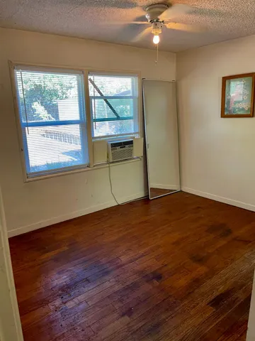 a view of a yard with plants and trees