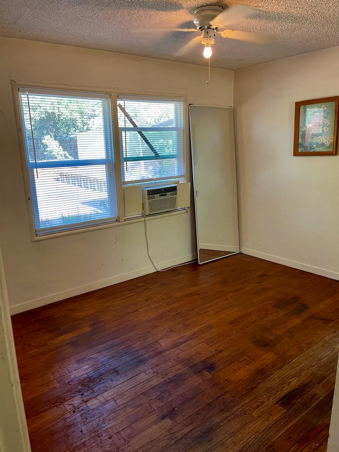 1736 6th Street Concord, CA 94519 - Photo 41 of 64 a view of empty room with wooden floor and fan