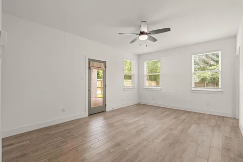 a view of an empty room with wooden floor