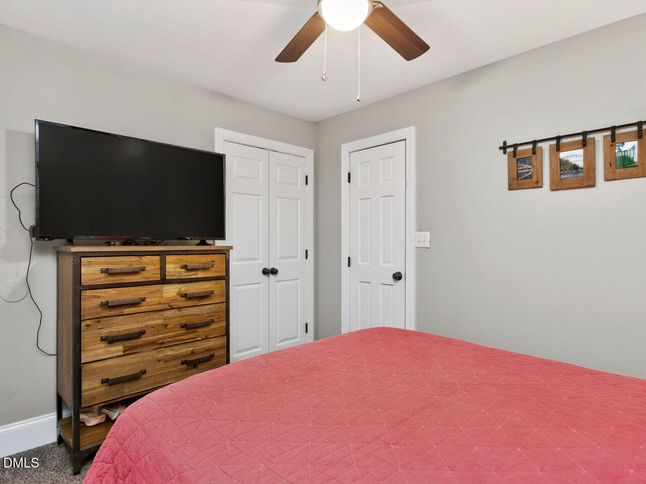 6004 Tarnhour Court Raleigh, NC 27612 - Photo 23 of 44 a bedroom with a bed and a flat screen tv