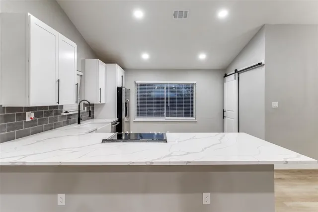 a bedroom with a large bed and a large mirror