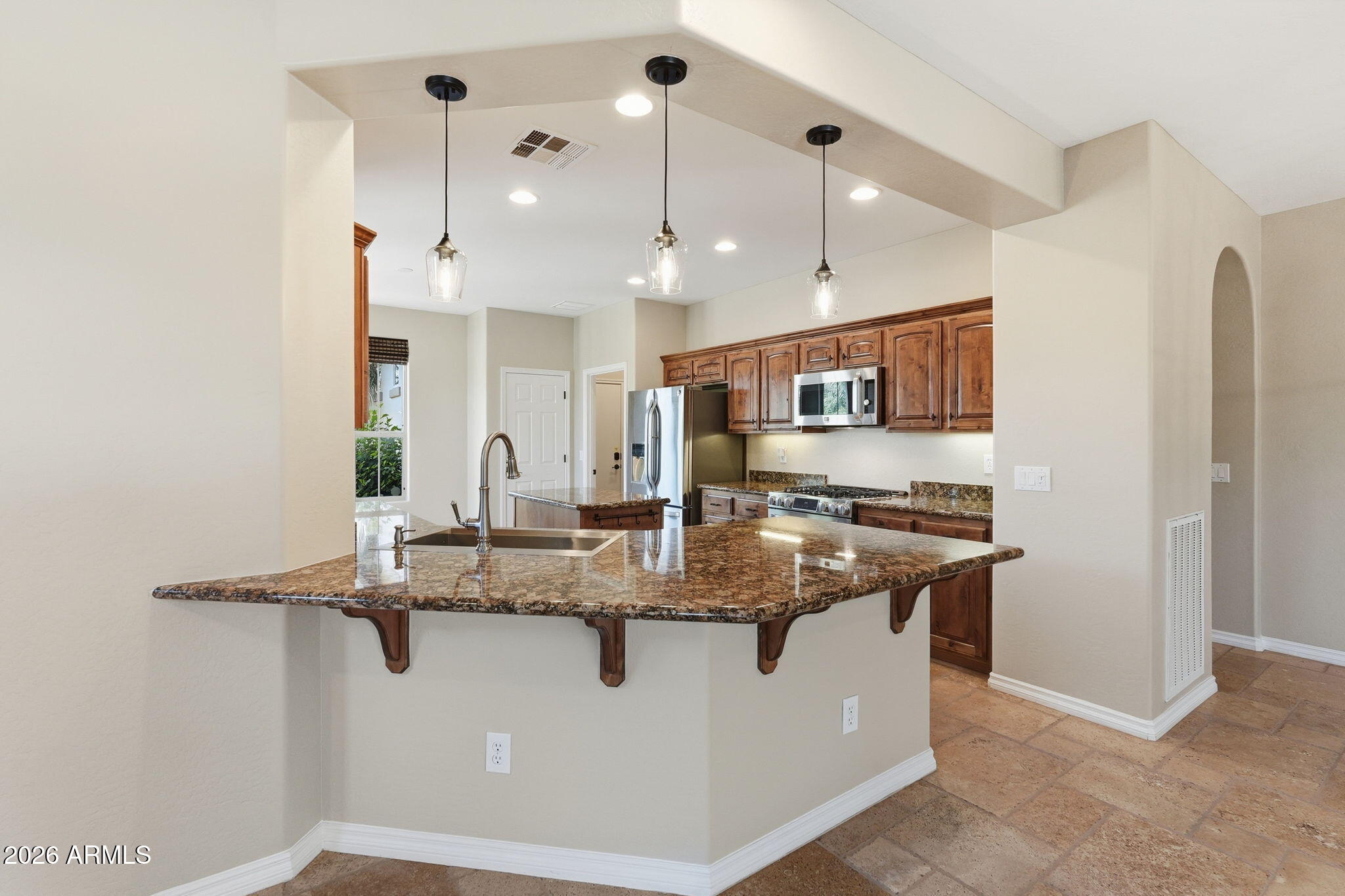 1694 East Grand Ridge Road Queen Creek, AZ 85140 - Photo 14 of 61 a kitchen with stainless steel appliances granite countertop a sink a refrigerator and a stove