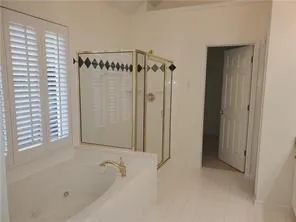 a bathroom with a bathtub and a shower
