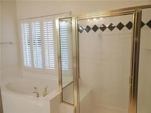 a bathroom with a bathtub and shower