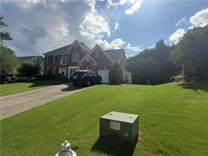 3715 Ridgeside Court Suwanee, GA 30024 - Photo 33 of 33 a view of a big house with a big yard and large trees
