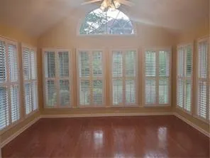 a view of wooden floor and windows in an empty room