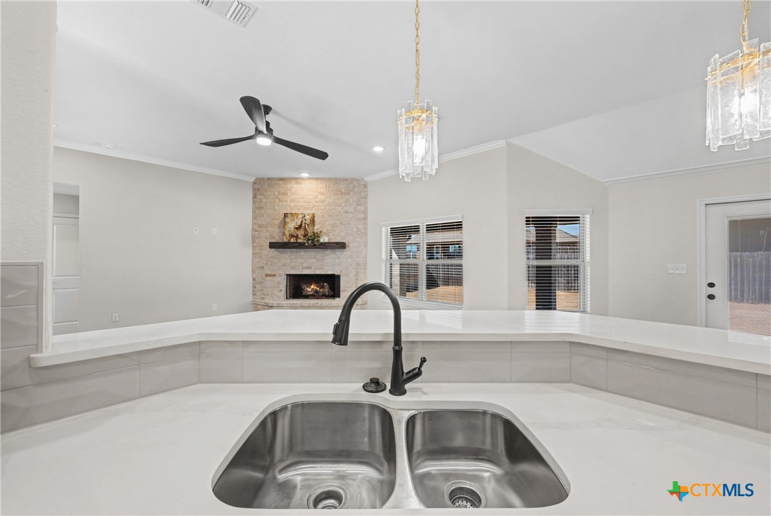 604 Magnolia Drive Troy, TX 76579 - Photo 14 of 33 a kitchen with a sink a counter space and cabinets