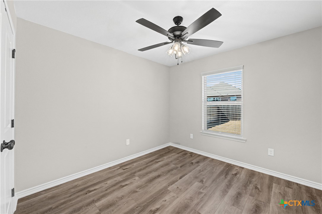 604 Magnolia Drive Troy, TX 76579 - Photo 15 of 33 an empty room with wooden floor and windows