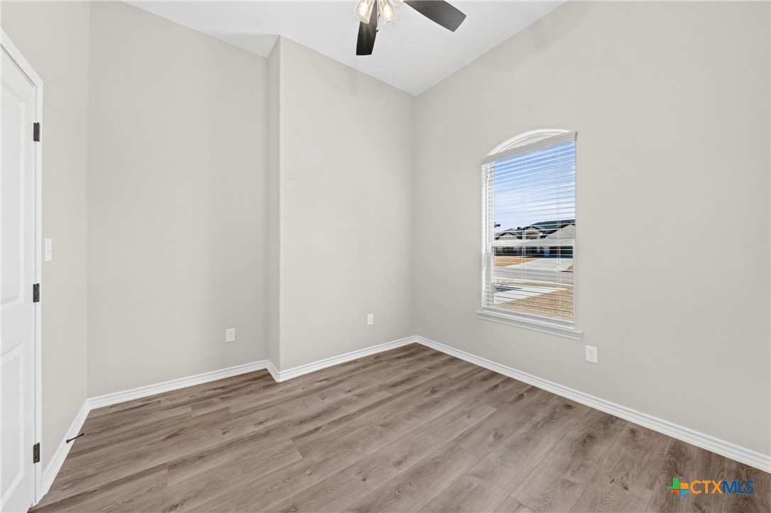 604 Magnolia Drive Troy, TX 76579 - Photo 17 of 33 an empty room with a window and a ceiling fan