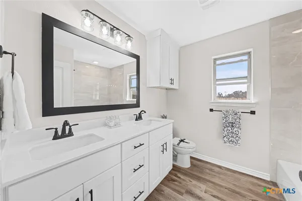a bathroom with a bathtub with shower