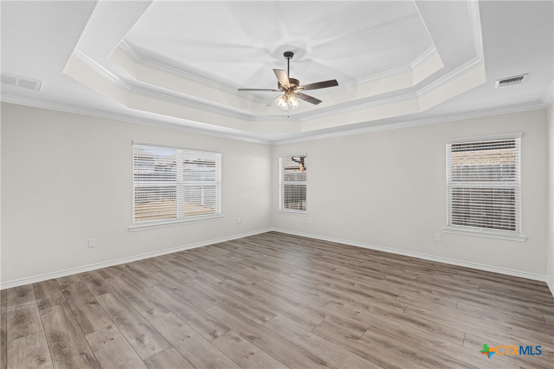 604 Magnolia Drive Troy, TX 76579 - Photo 24 of 33 an empty room with wooden floor chandelier fan and windows
