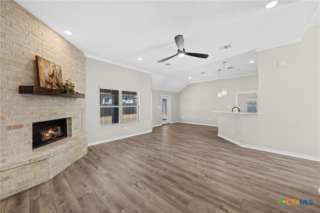 604 Magnolia Drive Troy, TX 76579 - Photo 7 of 33 a view of an empty room with a fireplace and a window