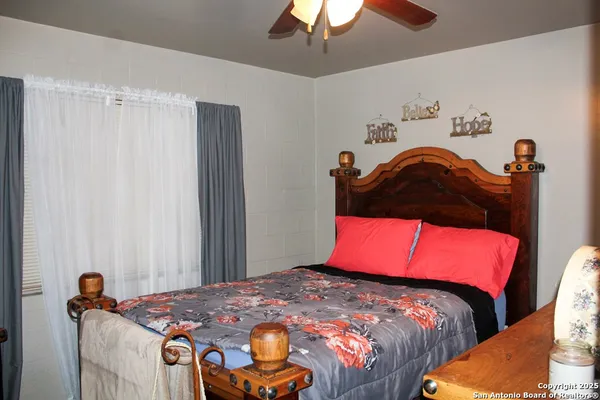a bedroom with bed and a chandelier