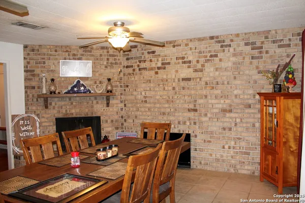 a dining room with furniture and a fireplace