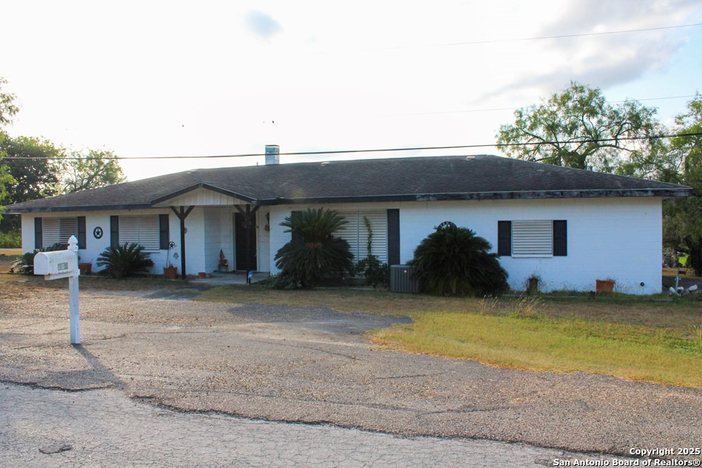 102 Holman Road Lake City, TX 78368 - Photo 26 of 27 a front view of a house with a garden and a tree