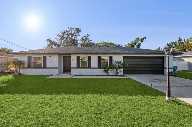 a front view of a house with a garden