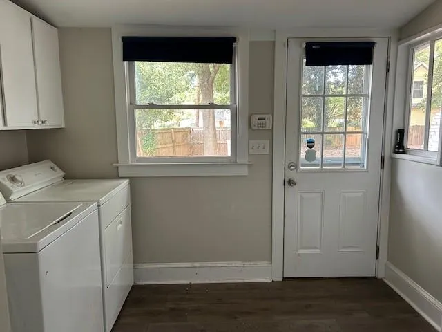 an empty room with wooden floor and cabinet